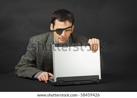 The computer pirate look with one eye on dark background