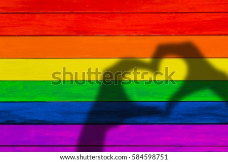 Boards in rainbow colors. Colorful wood background. gay flag, a shadow in the form of heart.
