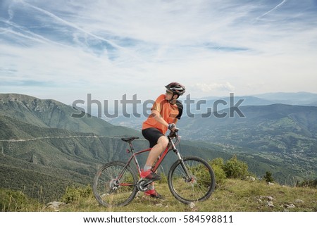 Young cyclist trains driving through a dangerous mountain, with rest and refreshment