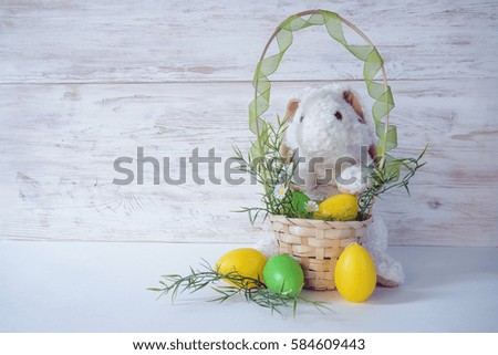 bunny with paints and eggs prepared to easter
