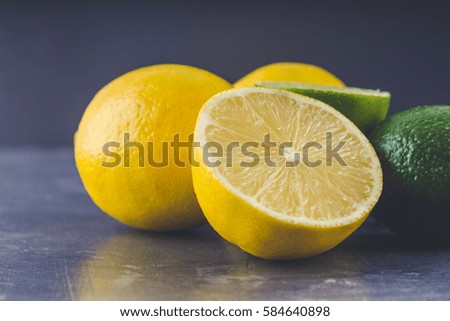 lemons and limes on a gray background.