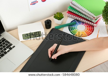 Young designer drawing sketches on graphic tablet