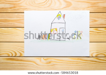 child's drawing. home happy family. wooden background