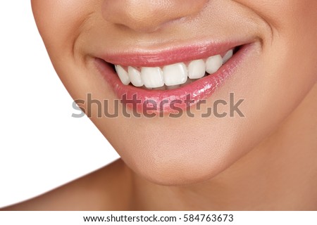 Beautiful smile with whitening teeth. Dental photo. Macro closeup of perfect female mouth, lipscare. Perfect pink lip makeup. Perfect clean skin, light fresh lip make-up. Isolated