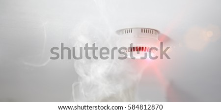 Smoke detector mounted on roof in apartment Royalty-Free Stock Photo #584812870