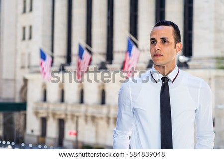 Portrait of Businessman. Dressing in white shirt, black tie, young handsome man standing outside office building with USA flags in New York, confidently looking forward. Color filtered effect
