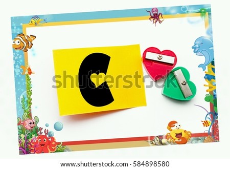 conceptual image/frame of two shapeners/sign note alphabet-C with isolated white background/selective f