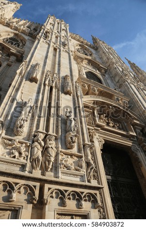 Milan, Italy Detail of Facade of Gothic Cathedral called Duomo di Milan in Italy wtih blue sky