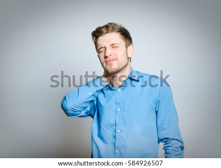 man has a sore neck, isolated on a gray background