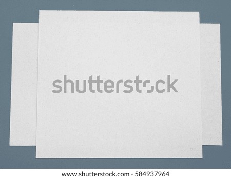 3 paper abstract on gray background.