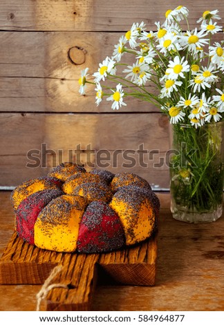 Carrot and beetroot bread with poppy seeds on a wooden board