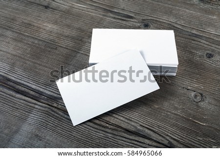 Blank business cards on a wooden table background for placing your design. Template for ID.