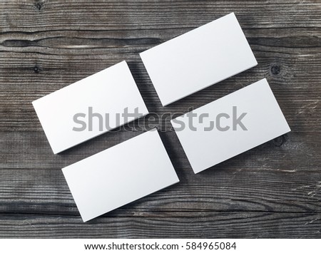 Four blank piles of business cards on wooden table background. Template for placing your design. Blank stationery mock up. Top view.