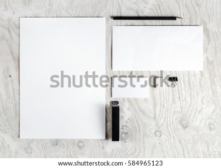 Photo of blank stationery set. Corporate identity template on light wooden background. Mock up for placing your design. Responsive design mockup. Top view.
