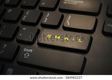 Keyboard button written " EMAIL " in yellow.