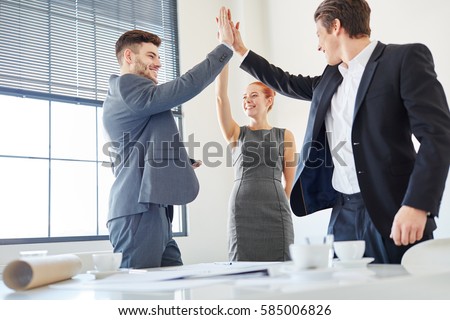 Business people giving High Five as motivation for success Royalty-Free Stock Photo #585006826