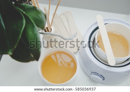 hot wax in white bowl for Hair removal Royalty-Free Stock Photo #585036937