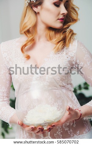 Beautiful girl in a white dressing gown. Young bride in white in the morning. Wedding