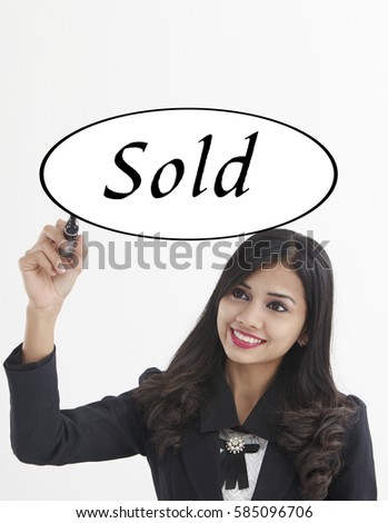 businesswoman holding a marker pen writing -sold