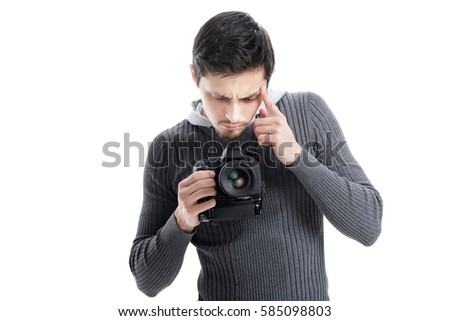 young photographer sets up the camera isolated on white backgrou
