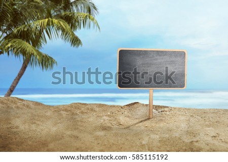Blank wooden sign on sand at the beach