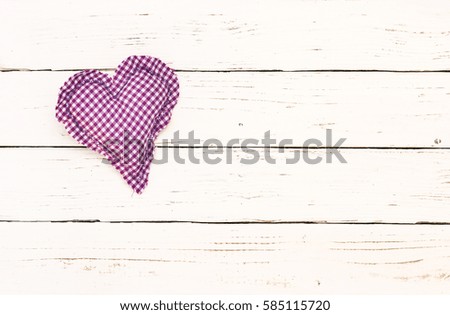 Decorative heart on white wood background with place for text.