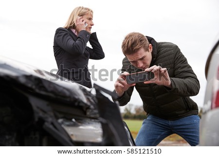 Drivers Taking Photo Of Car Accident On Mobile Phones