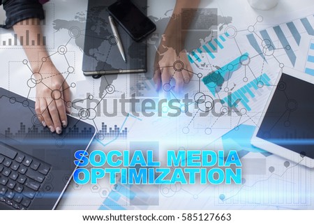 Woman working with documents, tablet pc and notebook and selecting social media optimization.