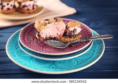 Delicious cookies with ice cream and chocolate chips on plate