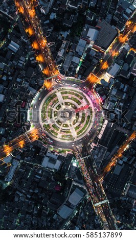 Road roundabout with car lots Wongwian Yai in Bangkok,Thailand. street large beautiful downtown at night light.  Aerial view , Top view ,cityscape ,Rush hour traffic jam