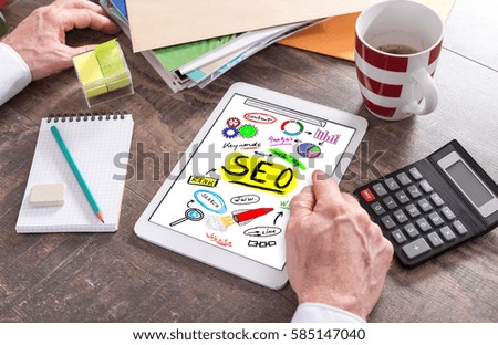 Man using a tablet showing a seo concept