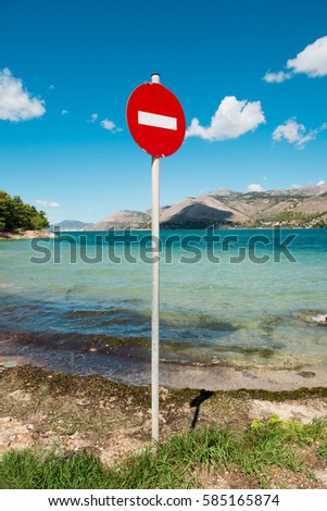 beach landscape with turquoise sea water and no entry sign in Argostoli, Greece