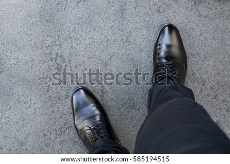Top view of businessman legs wearing black shoes walking go to dream