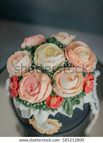 on a black background birthday cake decorated with beautiful roses