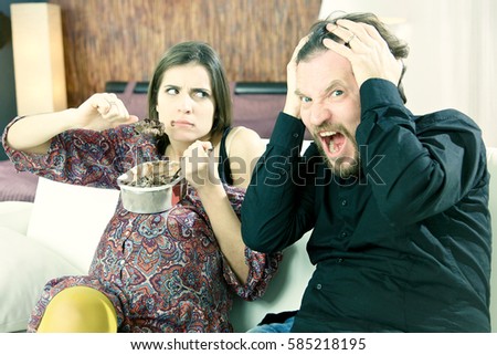 husband worried because his beautiful pregnant wife does not stop over eating Royalty-Free Stock Photo #585218195