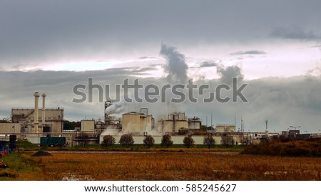 Factory smoke stack and pipes puff into air. Atmospheric air pollution industrial scene. Non-ecological and non-sustainable manufacturing.