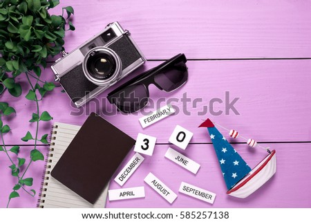 Travel gear on pink wooden background. Travel concept , top view
