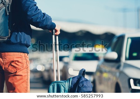 Airport taxi. Passenger is waiting for taxi car.  Royalty-Free Stock Photo #585257993