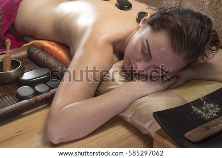 beautiful woman on stone massage