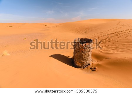 Dry water well in Erg chebbi desert, Merzouga, Morocco Royalty-Free Stock Photo #585300575