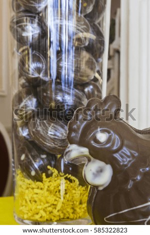 A hen in chocolate in a shop in France. The more traditional eggs can be seen in the background.