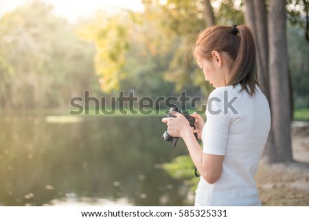 Woman taking photos with digital camera.