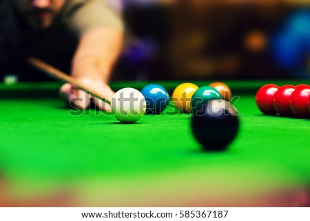 playing snooker - man aiming the cue ball Royalty-Free Stock Photo #585367187