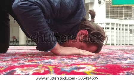 Photo of the Muslim Man Is Praying In The beautuful  Mosque with red carpets