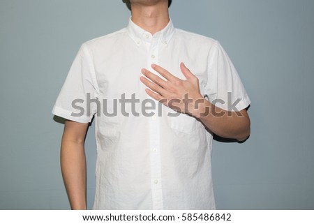 Asian man showing his heartfelt gratitude and thanks clasping his hand to his heart