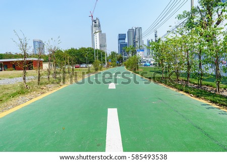 Green Bicycle lane in city. Bike lanes or cycle lanes are types of bikeways (cycleways) with lanes on the roadway for cyclists only.
