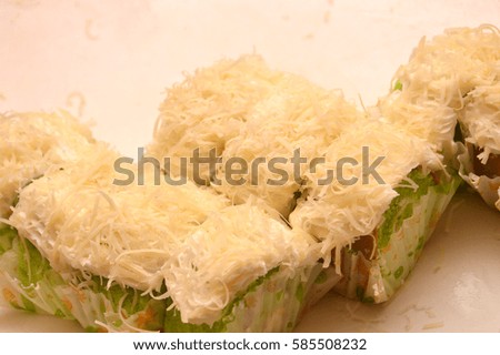 sponge cake with grated cheese on white plate