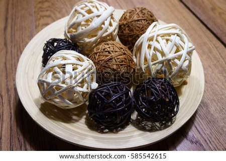 Bamboo ball are 3 color (white, black and brown)  on laminate dish wood with brown wood table in background. Kitchen and copy space in photo.