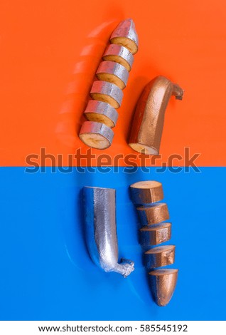 colored banana, orange and blue abstract background, bronze, silver banana