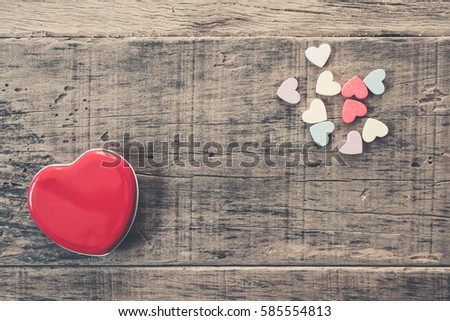 Colorful hearts on wood background. vintage retro color style.